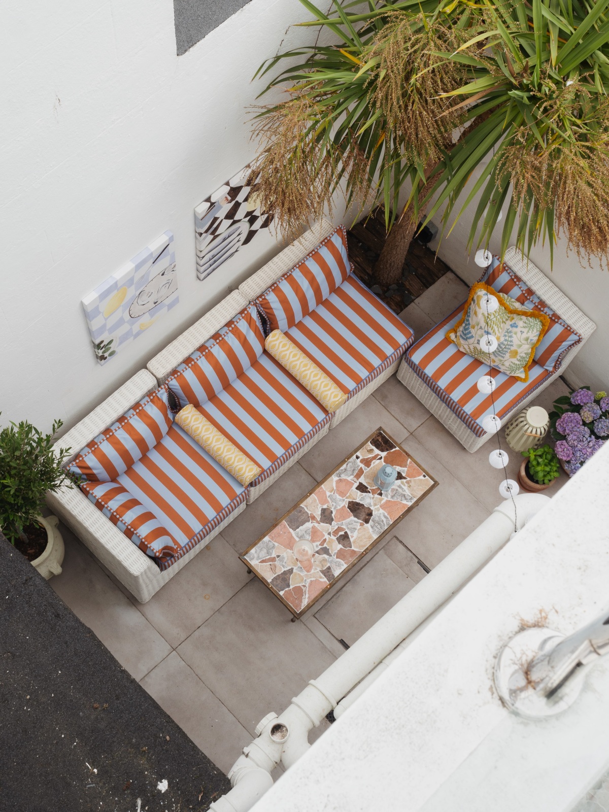 rooftop view, desenio outdoor wall art, awning stripe outdoor sofa, bolster cushion, marble pave table